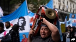 Un hombre toca un tambor durante una protesta para exigir empleos, beneficios sociales para los desempleados y más alimentos para los comedores populares en medio de una inflación vertiginosa, en Buenos Aires, Argentina, el 24 de agosto de 2023. (Foto AP/Victor R. Caivano )